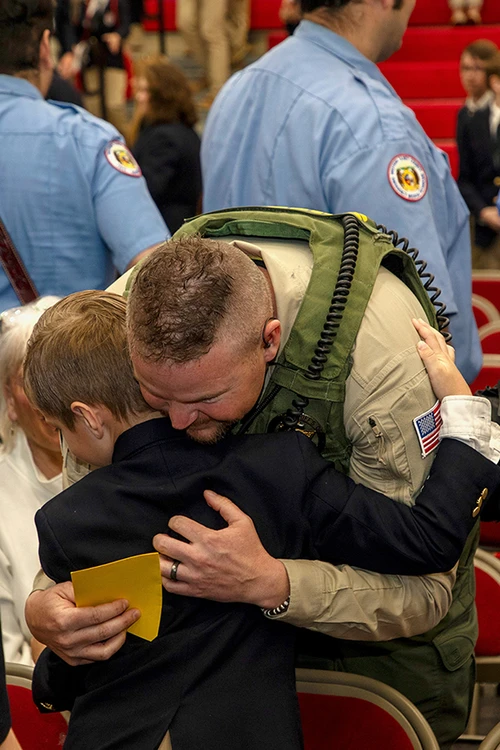 Caleb Leimkuehler, Stone County Sergeant, hugs his son, a S of O student. Students of School of the Ozarks presented first responders with thank you cards during the ceremony.   
